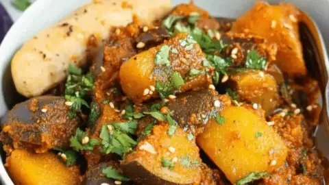 Bowl of Aloo Baingan, a traditional Indian dish with potatoes and eggplants