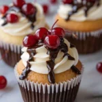 Boston Cream Pie Cupcakes topped with chocolate glaze and whipped cream.