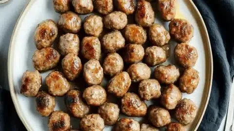 Chardonnay Italian sausage bites served on a platter with garnishes.