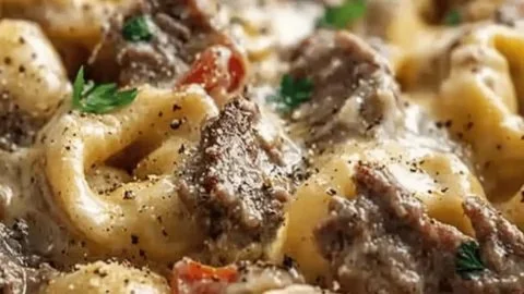 Cheesesteak Tortellini in rich provolone sauce served in a bowl