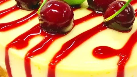 Delicious Cherry Limeade Cheesecake topped with cherries and lime zest