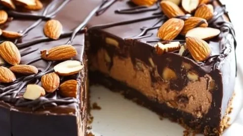 Delicious Chocolate Almond Cheesecake topped with almonds and chocolate drizzles
