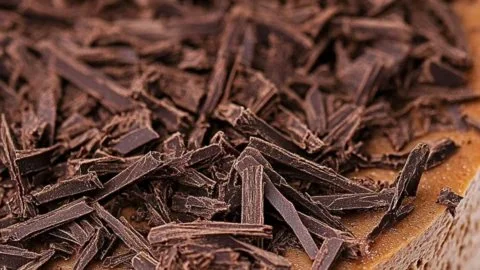 Delicious chocolate cheesecake topped with chocolate shavings and whipped cream