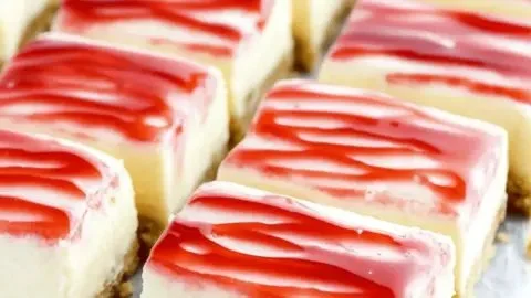 Creamy Philadelphia cheesecake bars topped with fresh strawberries