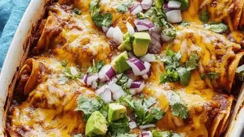 Delicious vegetarian enchilada casserole on a plate garnished with fresh herbs