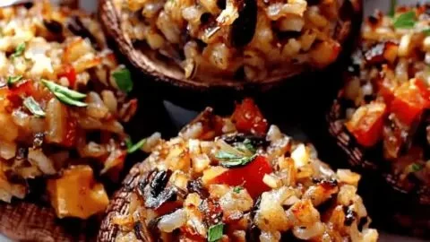 Vegetarian wild rice stuffed mushrooms arranged on a platter