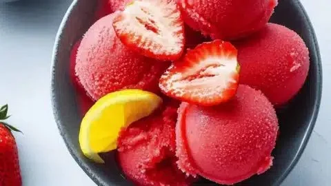A bowl of homemade strawberry sorbet made with four simple ingredients.