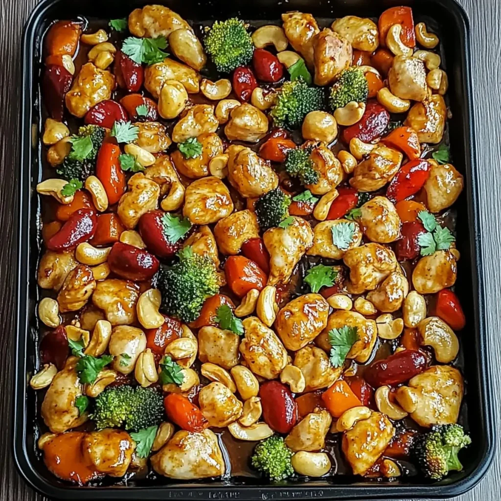 Delicious sheet pan cashew chicken served with vegetables on a rustic table