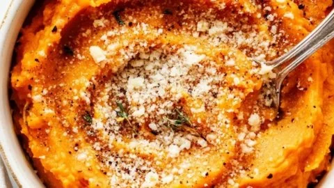 Roasted Garlic Parmesan Sweet Potatoes garnished and ready to eat