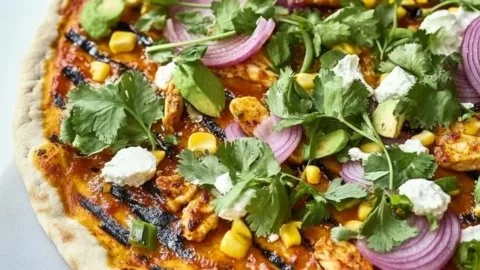 Delicious grilled BBQ chicken pizza with cheese and fresh toppings