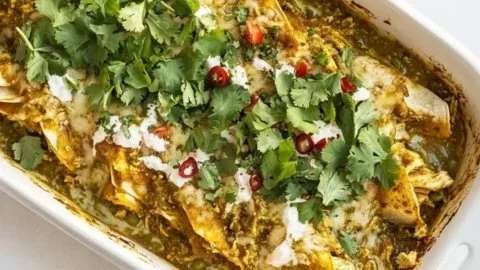 Delicious homemade green chicken enchiladas served on a plate.