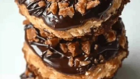 Freshly baked homemade Samoas cookies topped with chocolate and caramel