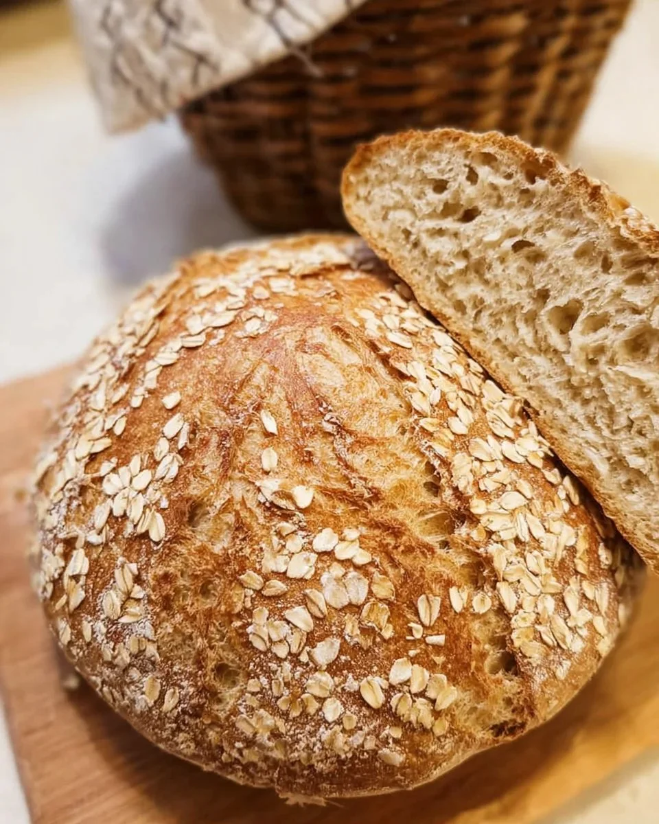 Freshly baked Honey Oat Sourdough bread loaf with a golden crust
