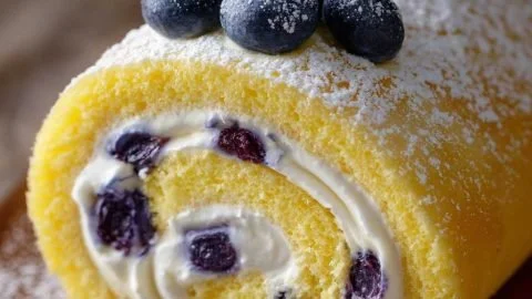 Lemon Blueberry Sponge Cake Roll dessert on a serving plate