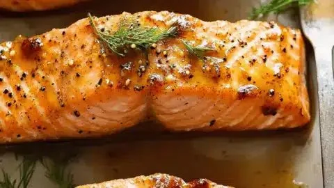 Maple Mustard Glazed Salmon dish garnished with herbs