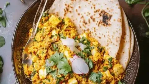 Delicious Paneer Bhurji served with garnishes on a plate