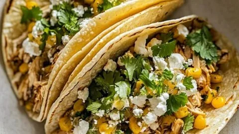 Delicious slow cooker chicken tacos topped with fresh ingredients