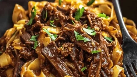 Delicious short rib ragu served with pasta in a rustic bowl