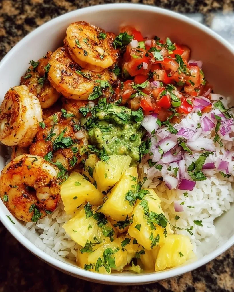 Shrimp rice bowl topped with vibrant pineapple salsa for a fresh and tasty meal.