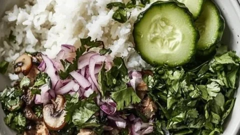 Simple Chicken Mushroom Larb bowls topped with fresh herbs and vegetables