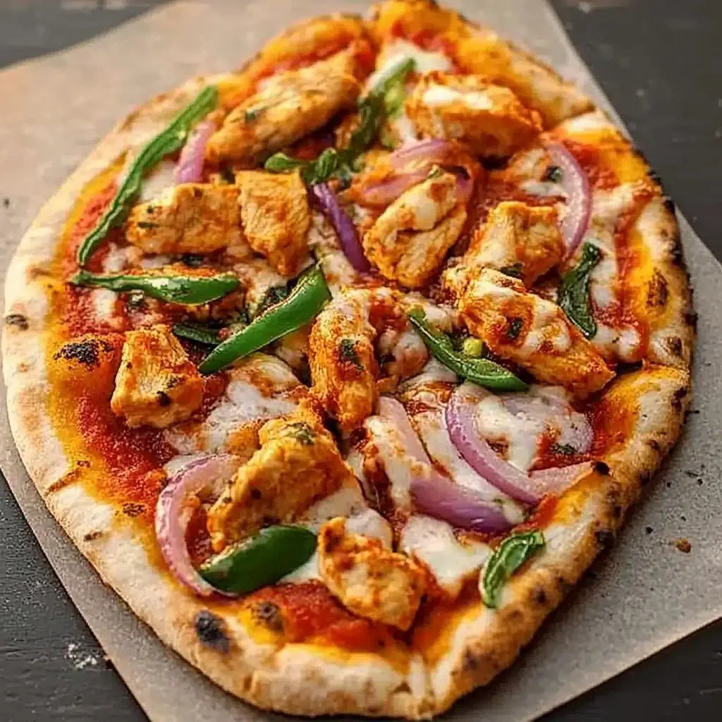 Delicious Chicken Tikka Pizza topped with spicy chicken and fresh ingredients