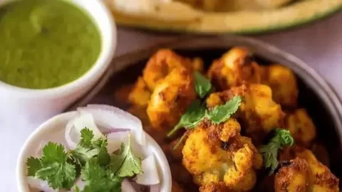 Plate of Tandoori Gobi, roasted cauliflower seasoned with spices.