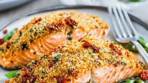 Delicious sun-dried tomato parmesan crusted salmon dish on a plate