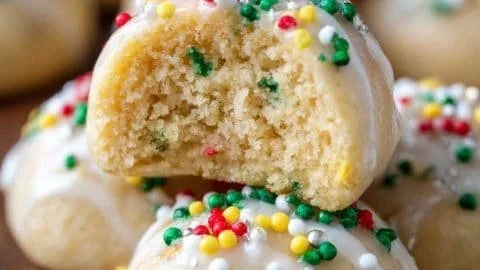 Plate of traditional Italian Christmas cookies decorated with powdered sugar and sprinkles
