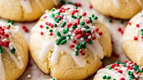 Plate of traditional Italian Christmas cookies decorated with colorful sprinkles