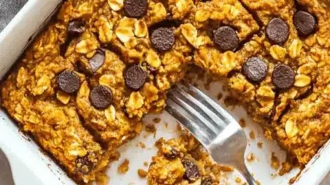 Warm pumpkin baked oatmeal in a bowl with autumn decorations