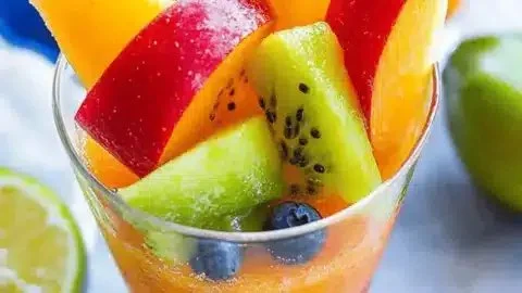 Colorful zesty Mexican fruit cups served as a refreshing summer snack