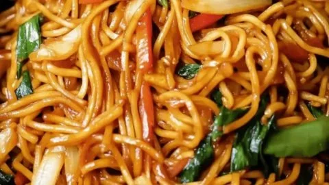 Bowl of 15-minute vegan lo mein with fresh vegetables and soy sauce