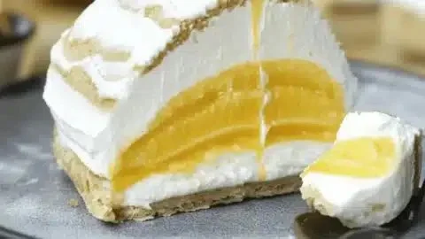 Delicious Brazo de Mercedes dessert with creamy filling and meringue layers.
