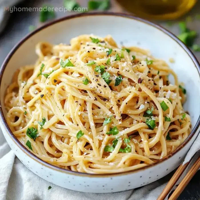 Delicious Garlic Noodles served in a bowl with fresh herbs and seasonings.