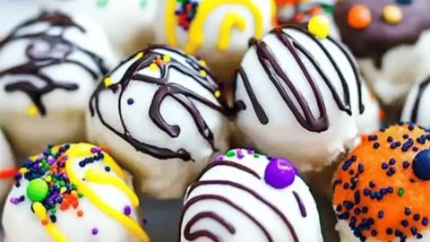 Halloween Cookie Dough Truffles displayed on a spooky-themed platter