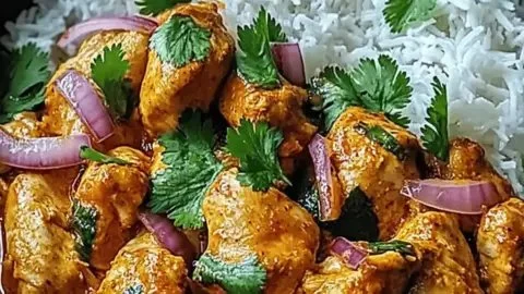 Spicy Brazilian Coconut Chicken served with rice and vibrant vegetables