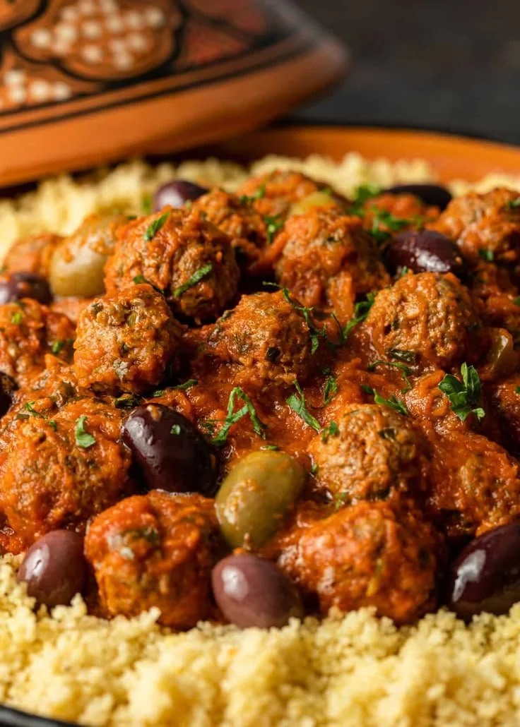 Plate of flavorful Moroccan meatballs garnished with herbs and spices