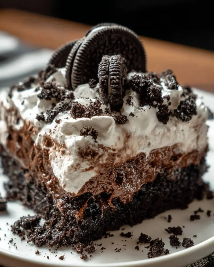 Delicious Oreo Poke Cake with chocolate and Oreo topping