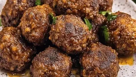 Savory bison meatballs with cranberries and wild rice served on a plate.