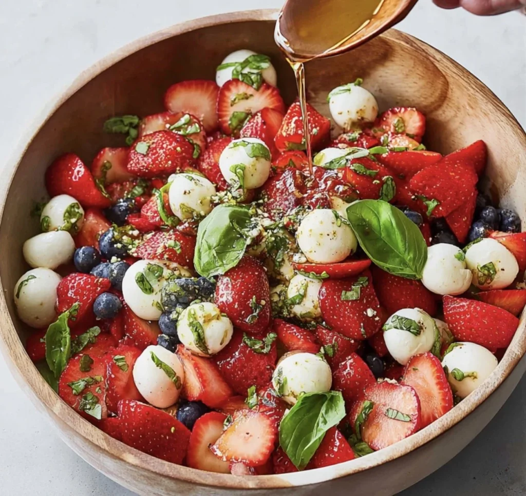 Strawberry Caprese Salad with mozzarella and basil served on a plate