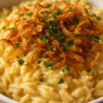 French Onion Chicken Orzo Casserole topped with melted cheese