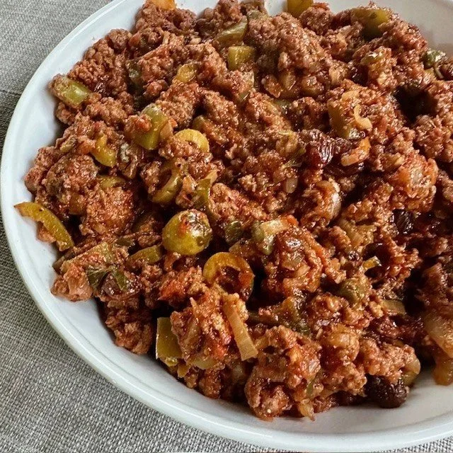 Delicious Cuban Beef Picadillo served with rice and olives.