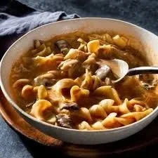 Bowl of delicious paprika chicken soup with fresh herbs and spices