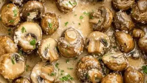 Delicious garlic parmesan sautéed mushrooms in a serving dish