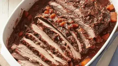 Delicious Jewish brisket served on a cozy family dinner table