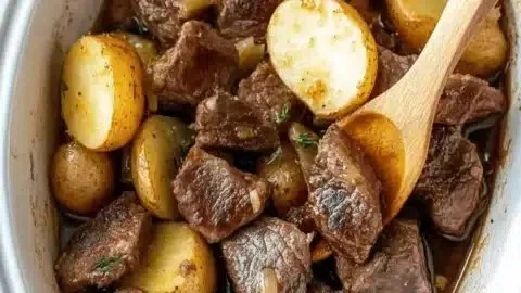 Savory slow cooker garlic butter steak bites served with potatoes