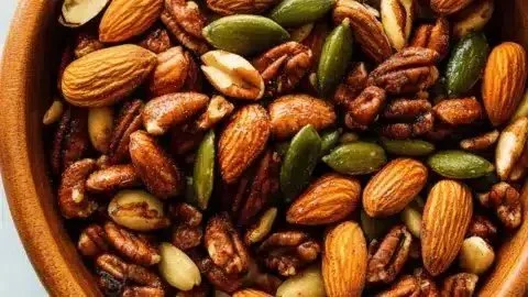 Bowl of spicy roasted party nuts, a perfect snack for gatherings and events.