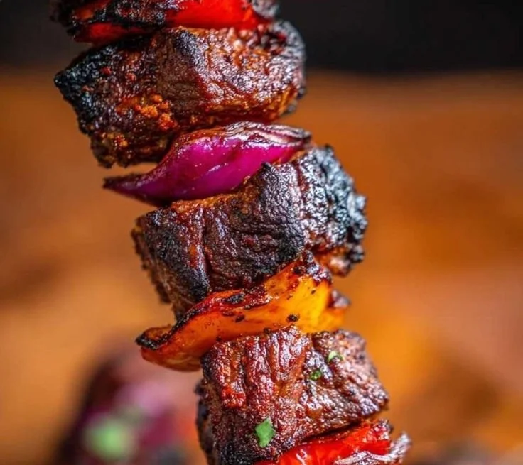 Juicy beef kebab skewers served with fresh vegetables and sauces