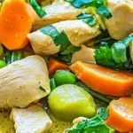 Bowl of delicious green Thai chicken coconut curry garnished with herbs