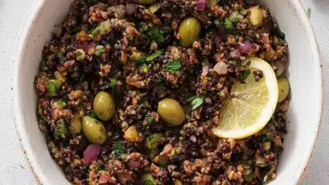 Delicious Mediterranean olive tapenade served with bread and crackers